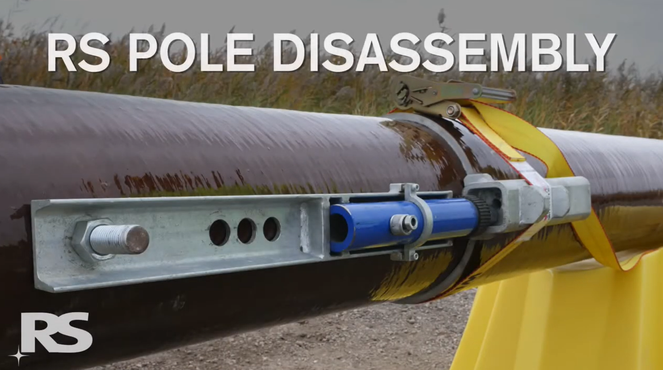 A close-up of a large pipe secured with a metal bracket and strap, labeled RS Pole Disassembly at the top. The RS logo appears in the bottom left corner.